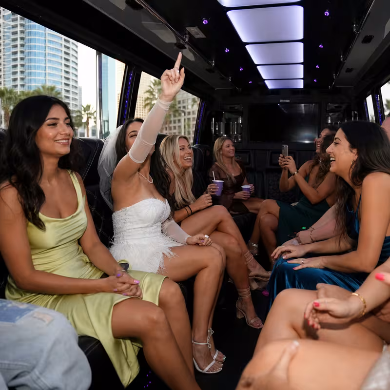 Party bus interior with wraparound leather seating and LED lighting in Tampa