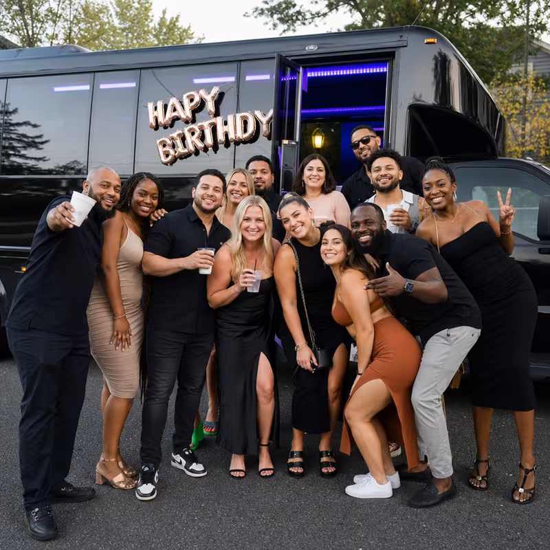 Group boarding a white charter bus for Birthday Transportation transportation in Tampa