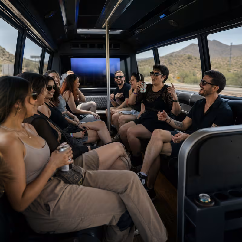 Group boarding a white charter bus for Concert Transportation transportation in Tampa