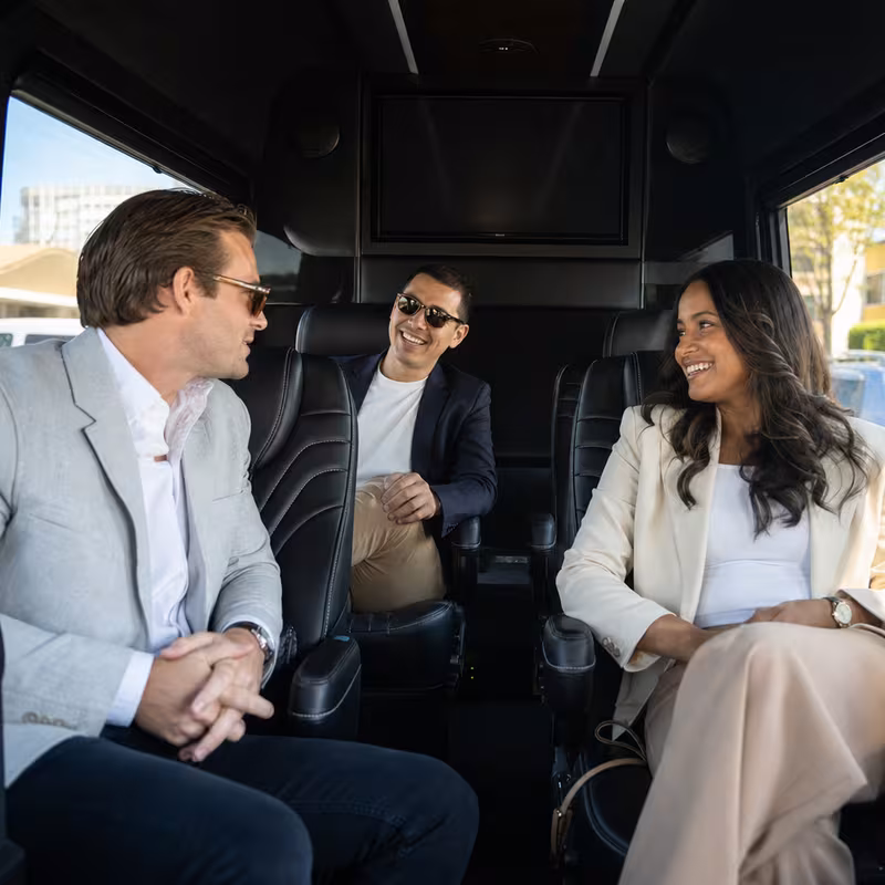 Group boarding a white charter bus for Corporate Transportation transportation in Tampa