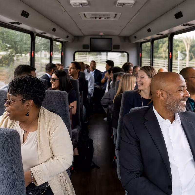Group boarding a white charter bus for Private Event Transportation transportation in Tampa