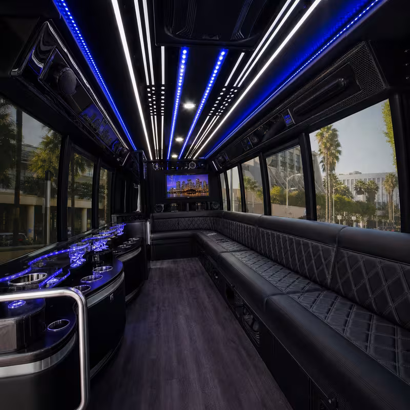 Party bus interior with wraparound leather seating and LED lighting in Tampa