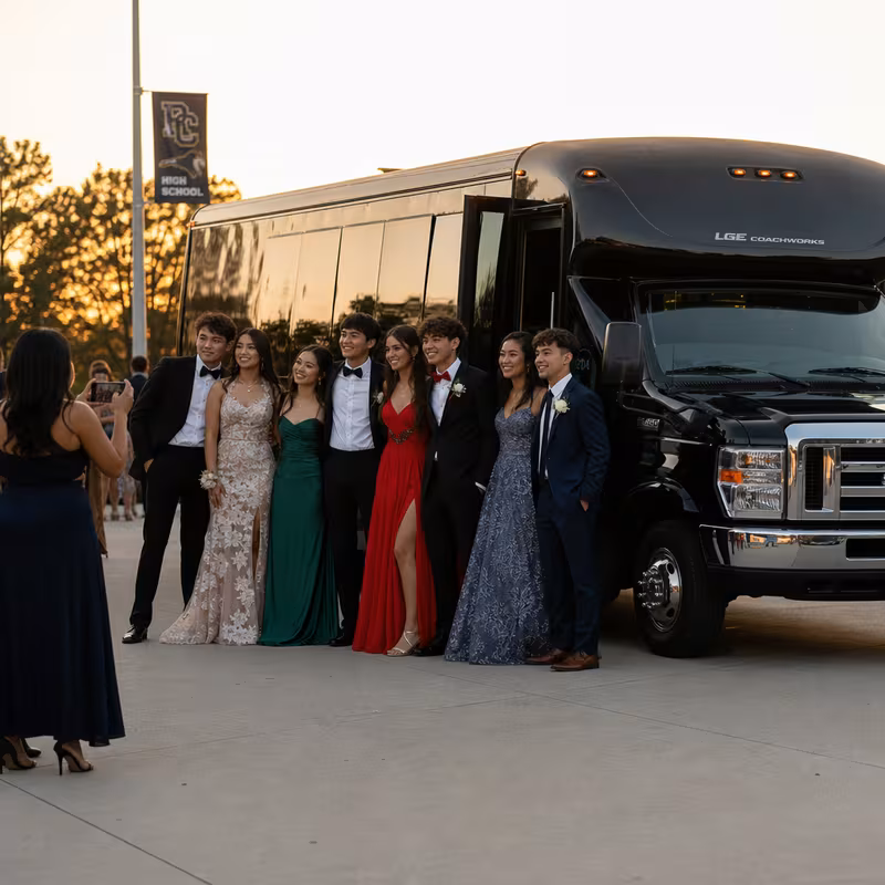 Group boarding a white charter bus for Prom & Homecoming Transportation transportation in Tampa