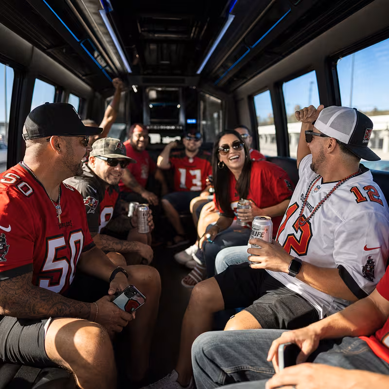 Group boarding a white charter bus for Sporting Event Transportation transportation in Tampa
