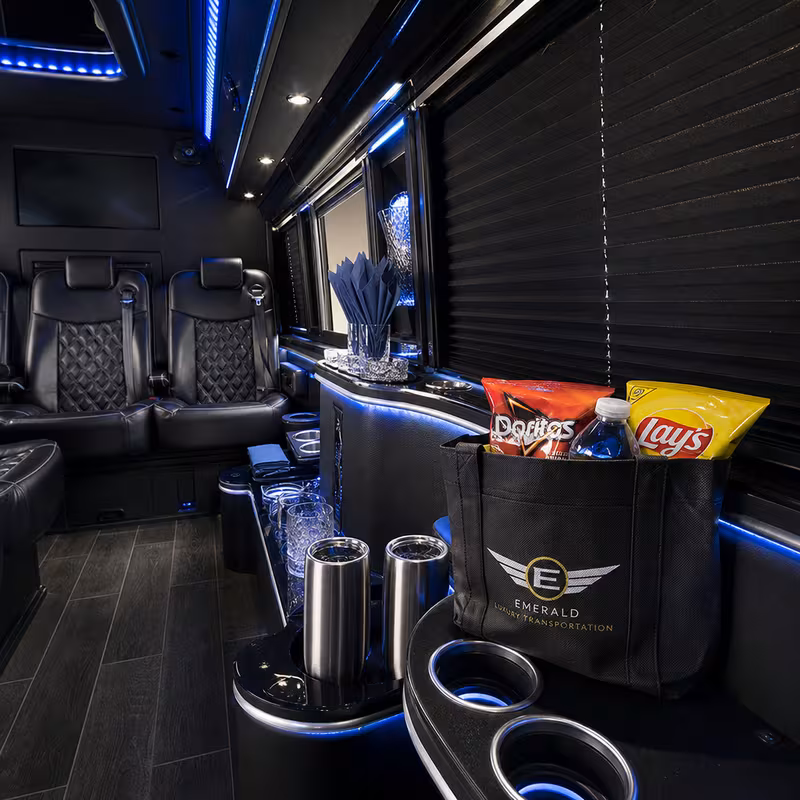 Party bus interior with wraparound leather seating and LED lighting in Tampa
